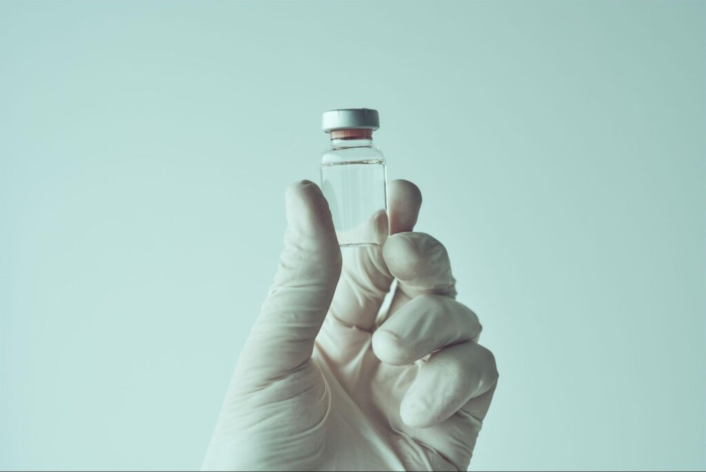 ヒアルロン酸のバイアルを持つ手